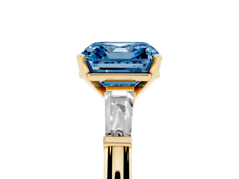 Fancy Blue Asscher Cut Diamond Solitaire Ring Set in Yellow gold with Tapered Baguette Side Stones and Prong Setting