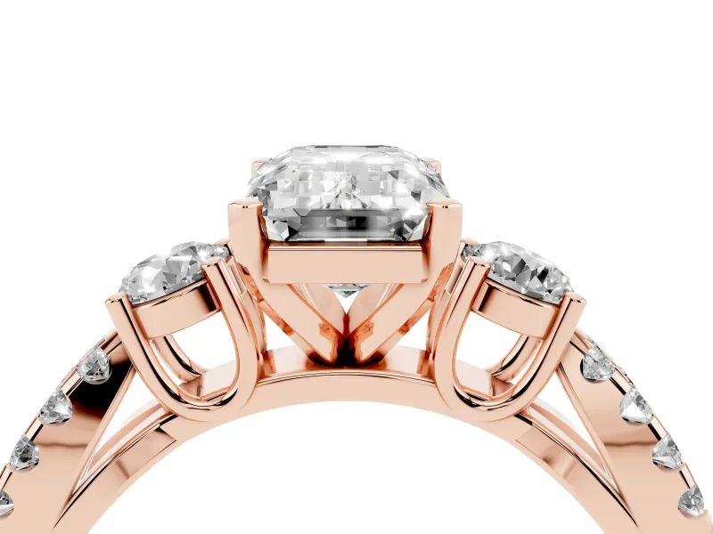 Emerald Cut Diamond Three-Stone Ring Set in Rose gold with Pavé Split Shank and Prong Setting