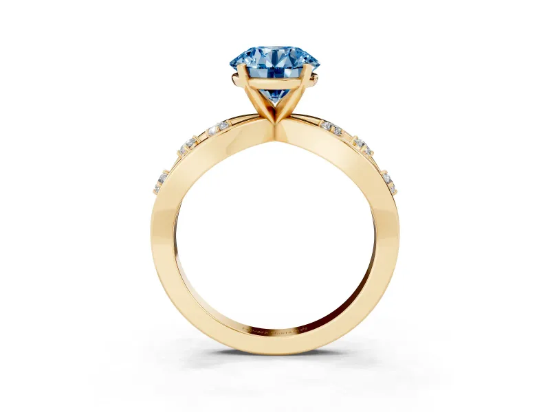 Fancy Blue Round Cut Diamond Solitaire Ring Set in Yellow gold with Side Stones on Criss-Cross Band and Prong Setting