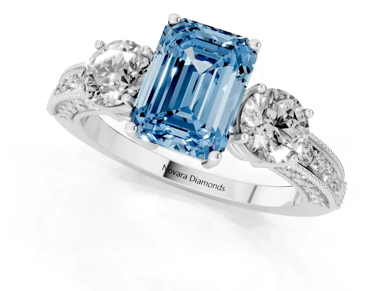 Fancy Blue Emerald Cut Diamond Three-Stone Ring Set in White gold with Round Side Stones and Pavé Band