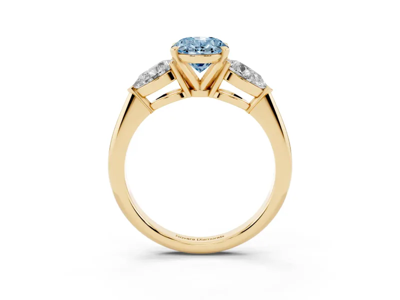 Fancy Blue Three-Stone Oval Cut Diamond Ring Set in Yellow gold with Pear Side Stones and Prong Setting