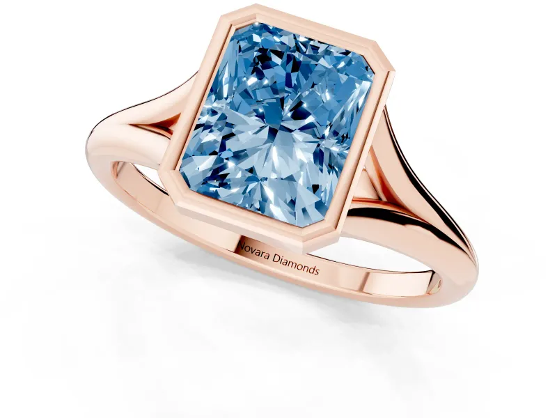 Fancy Blue Bezel Set Radiant Cut Diamond Solitaire Ring Set in Rose gold with Tapered Band