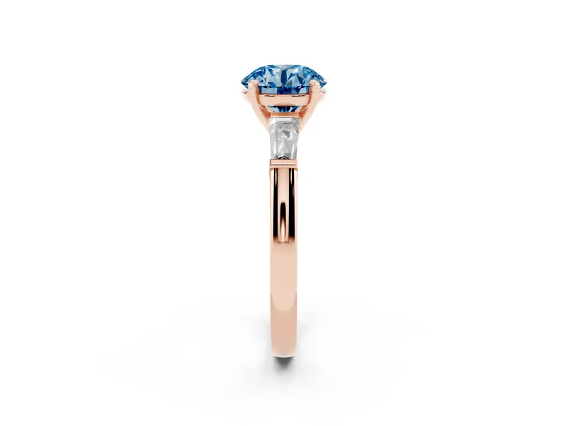 Fancy Blue Round Cut Diamond Solitaire Ring Set in Rose gold with Tapered Baguette Side Stones and Prong Setting