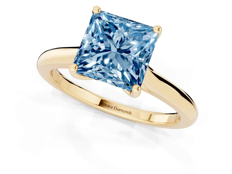Fancy Blue Princess Cut Diamond Solitaire Ring Set in Yellow gold with Cathedral Band and Prong Setting