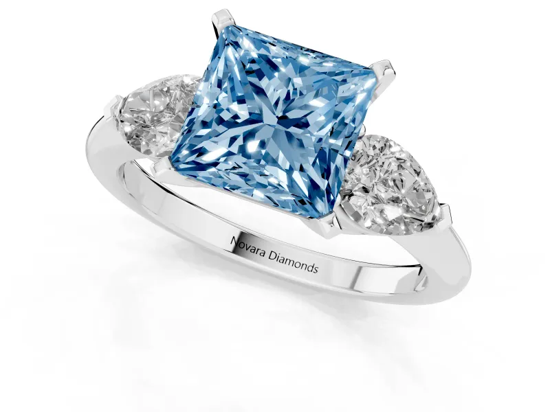 Fancy Blue Three-Stone Princess Cut Diamond Ring Set in Platinum with Pear Side Stones and Prong Setting