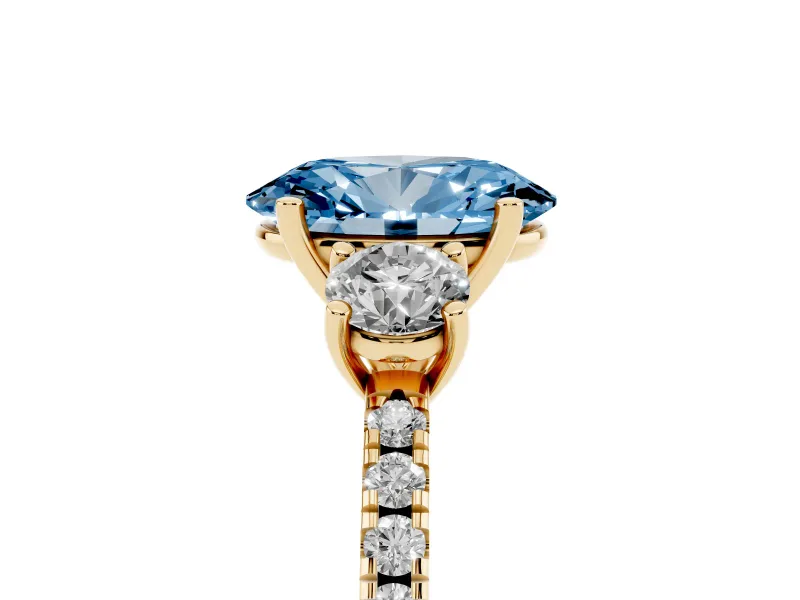 Fancy Blue Oval Cut Diamond Three-Stone Ring Set in Yellow gold with Pavé Band and Graduated Sides