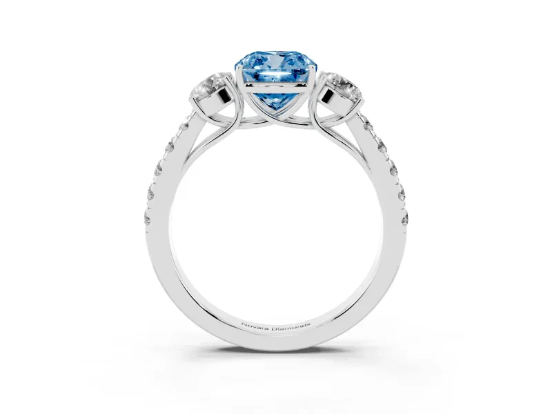 Fancy Blue Cushion Cut Diamond Three-Stone Ring Set in White gold with Round Side Stones and Delicate Pavé Band