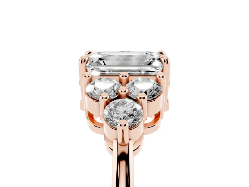 Emerald Cut Diamond Solitaire Ring Set in Rose gold with Cluster Accents on Each Side
