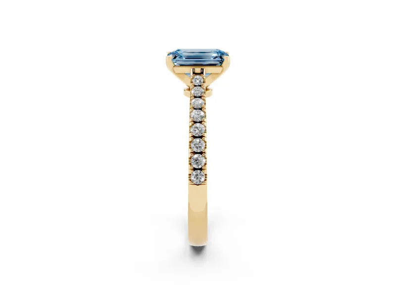 Fancy Blue Emerald Cut Diamond Solitaire Engagement Ring Set in Yellow gold with Delicate Pavé Band and Prong Setting