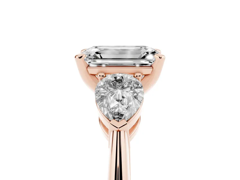 Three-Stone Emerald Cut Diamond Ring Set in Rose gold with Pear Side Stones and Prong Setting