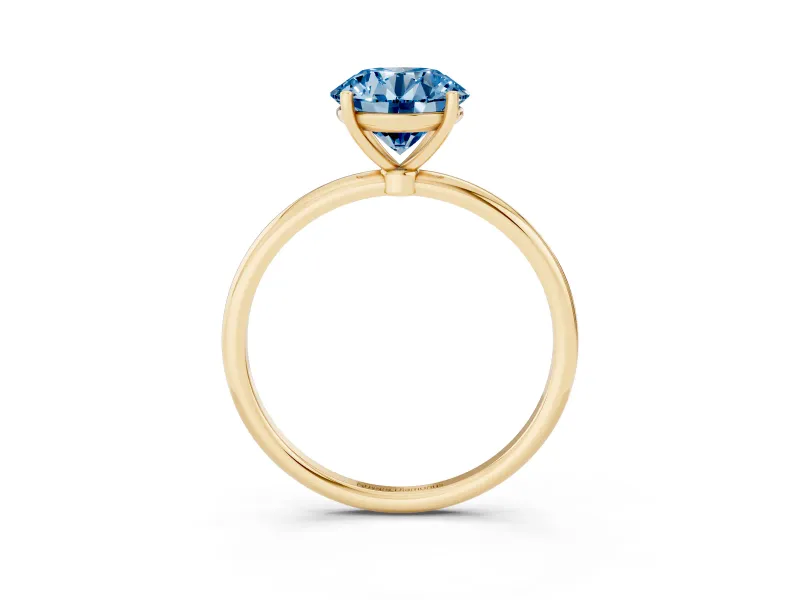 Fancy Blue Round Cut Diamond Solitaire Engagement Ring Set in Yellow gold with Thin Band and Prong Setting