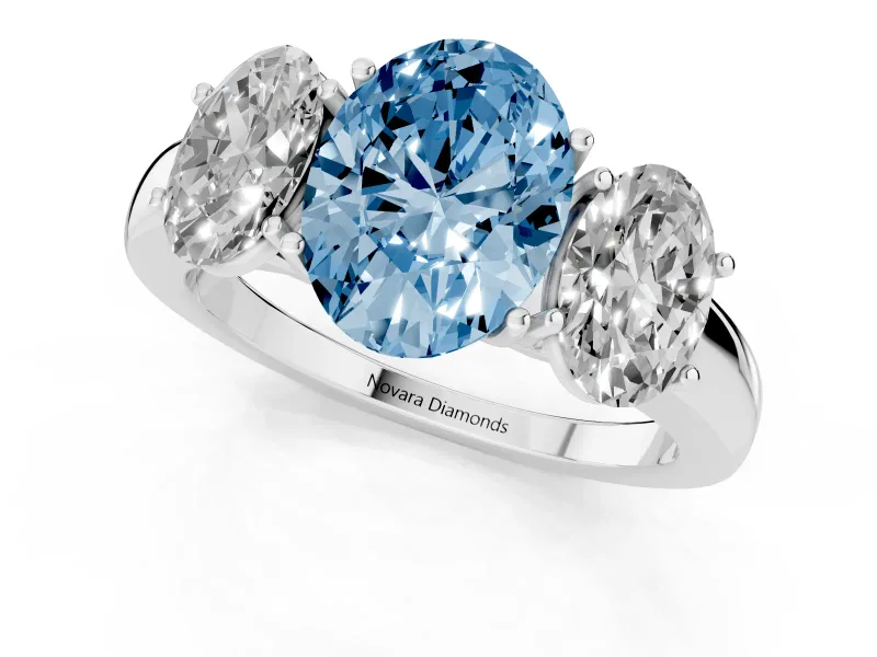 Fancy Blue Oval Cut Diamond Three-Stone Ring Set in Platinum with Bold Center and Classic Band