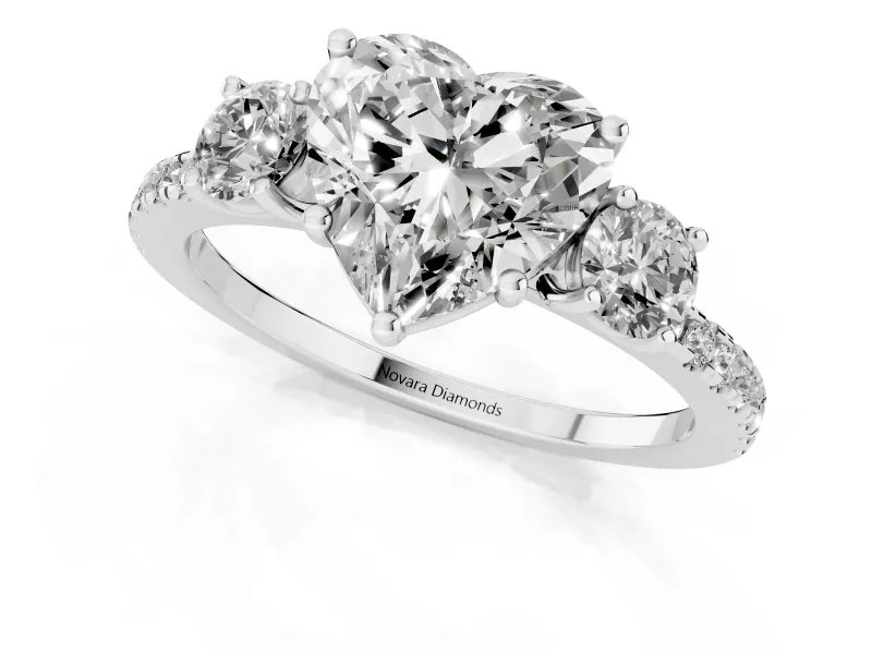 Heart Cut Diamond Three-Stone Ring Set in Platinum with Pavé Band and Graduated Sides