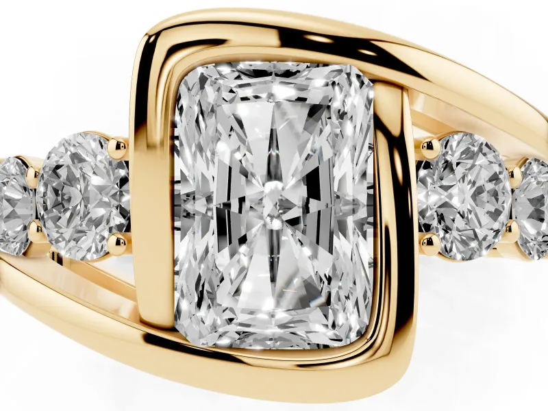 Radiant Cut Diamond Bezel Bypass Ring Set in Yellow gold with Round Accents
