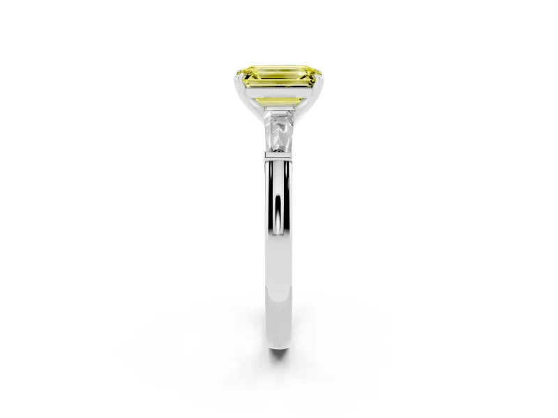 Fancy Yellow Emerald Cut Diamond Solitaire Ring Set in White gold with Tapered Baguette Side Stones and Prong Setting