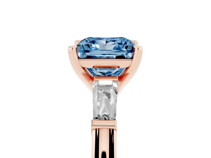 Fancy Blue Princess Cut Diamond Solitaire Ring Set in Rose gold with Tapered Baguette Side Stones and Prong Setting