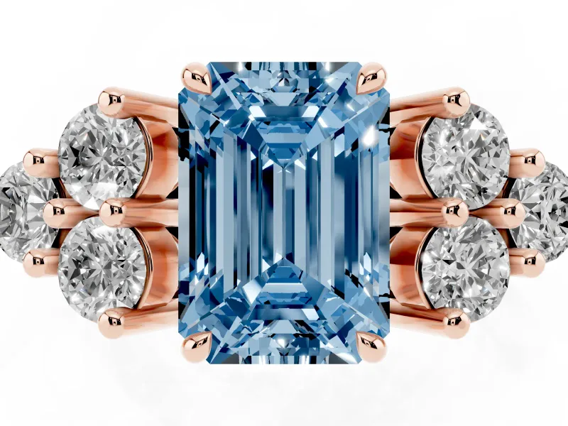 Fancy Blue Emerald Cut Diamond Solitaire Ring Set in Rose gold with Cluster Accents on Each Side