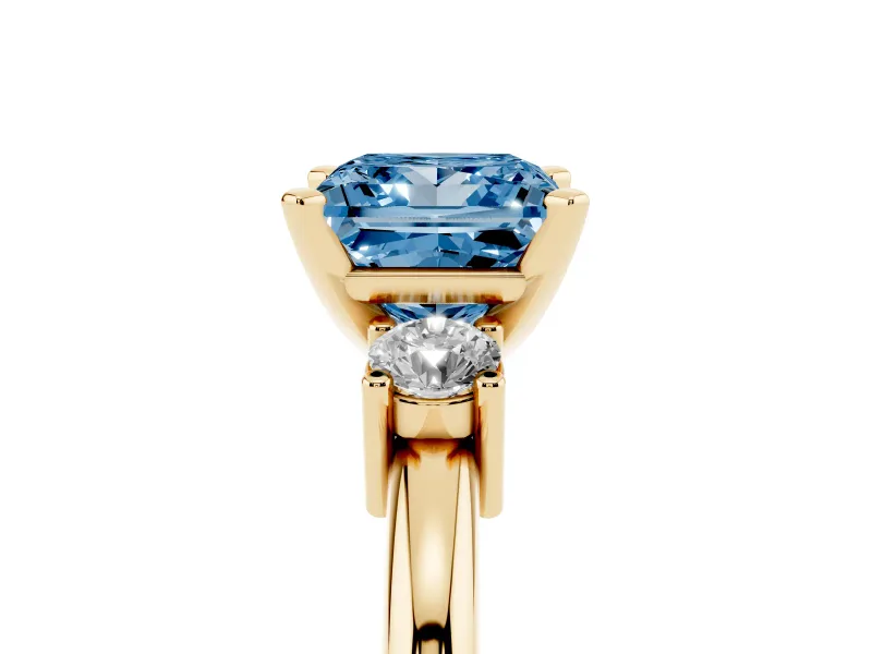 Fancy Blue Three-Stone Princess Cut Diamond Ring Set in Yellow gold with Prong Setting and Plain Band