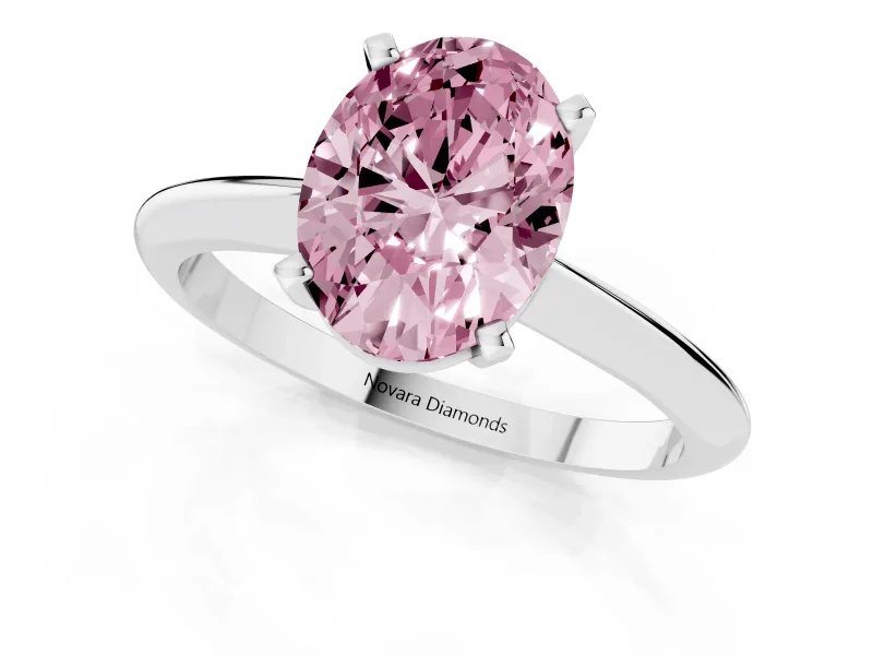 Fancy Pink Oval Cut Diamond Solitaire Ring Set in Silver with Prong Setting on a Plain Round Band