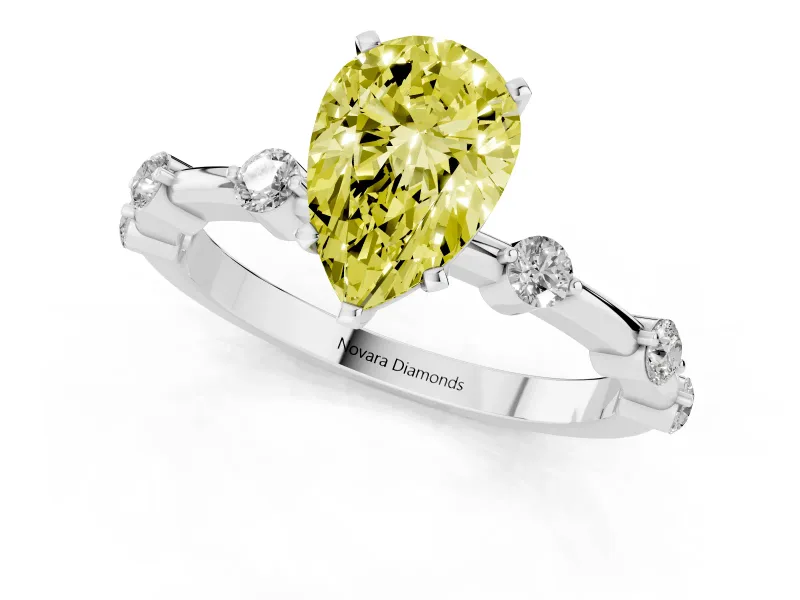 Fancy Yellow Pear Cut Diamond Solitaire Ring Set in White gold with Bezel Set Side Stones and Prong Setting