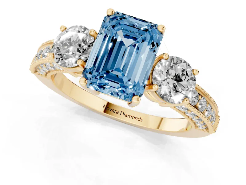 Fancy Blue Emerald Cut Diamond Three-Stone Ring Set in Yellow gold with Round Side Stones and Pavé Band