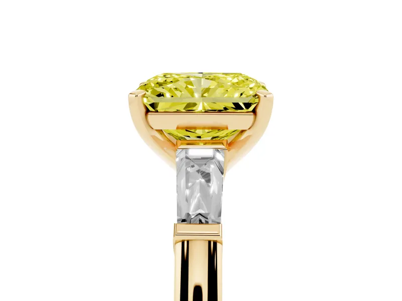Fancy Yellow Radiant Cut Diamond Solitaire Ring Set in Yellow gold with Tapered Baguette Side Stones and Prong Setting