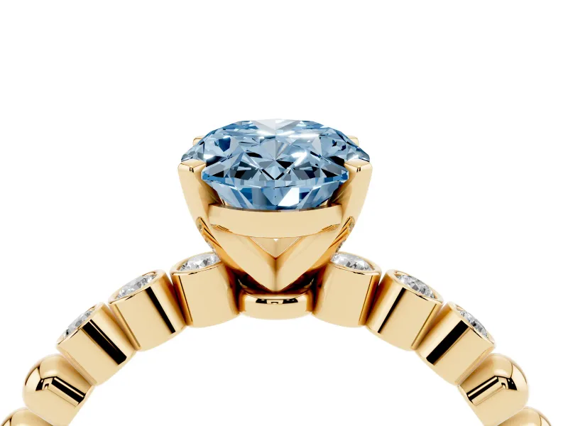 Fancy Blue Oval Cut Diamond Solitaire Engagement Ring Set in Yellow gold with Bezel Accents on Beaded Band