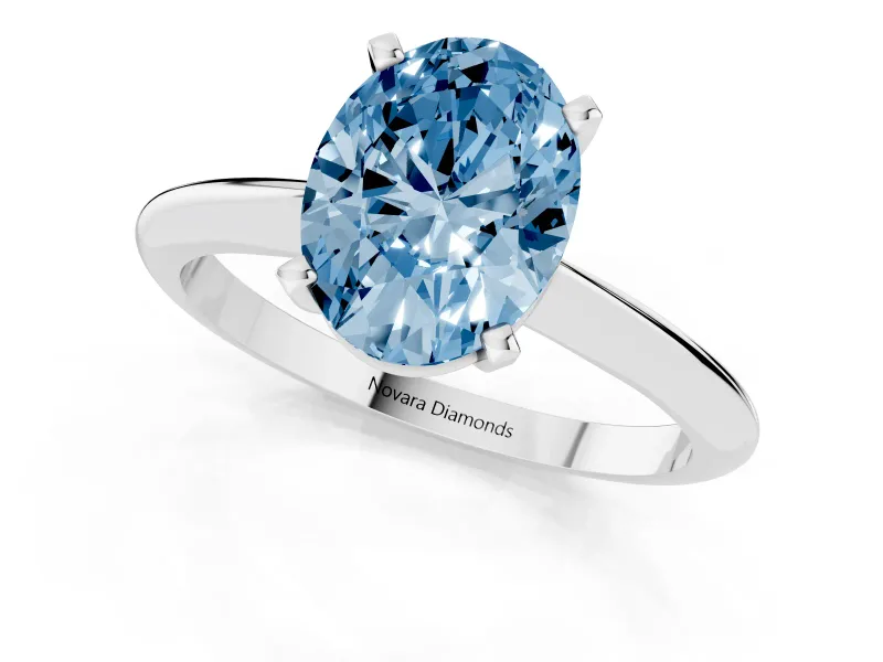 Fancy Blue Oval Cut Diamond Solitaire Ring Set in White gold with Prong Setting on a Plain Round Band