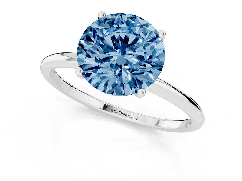 Fancy Blue Round Cut Diamond Solitaire Engagement Ring Set in Silver with Thin Band and Prong Setting