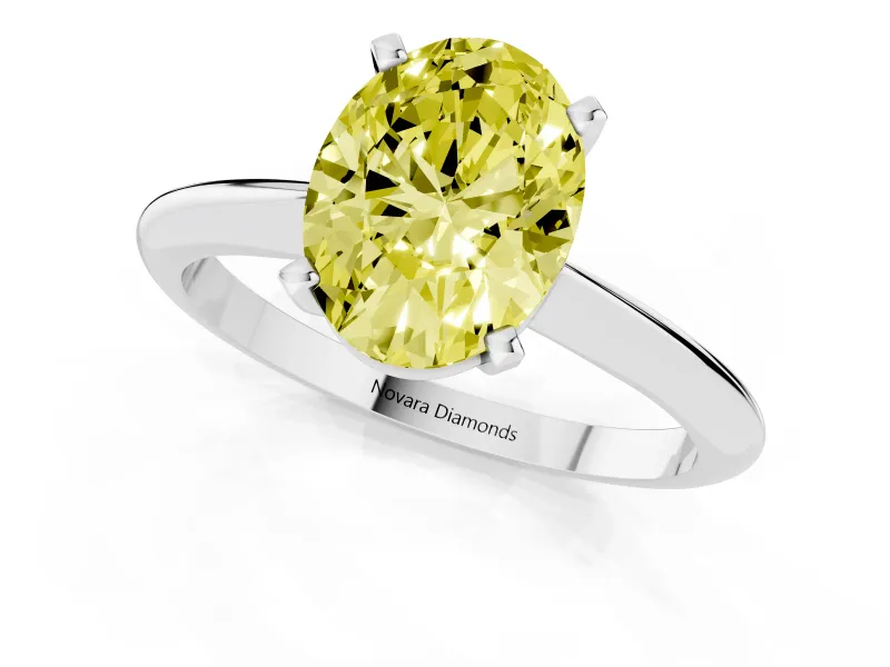 Fancy Yellow Oval Cut Diamond Solitaire Ring Set in Silver with Prong Setting on a Plain Round Band