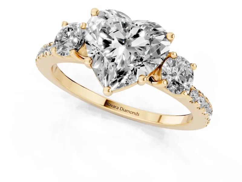 Heart Cut Diamond Three-Stone Ring Set in Yellow gold with Pavé Band and Graduated Sides