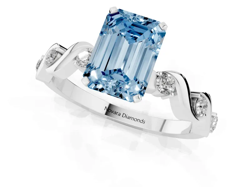 Fancy Blue Emerald Cut Diamond Solitaire Ring Set in White gold with Ribbon Twist Band, Round Accents and Prong Setting