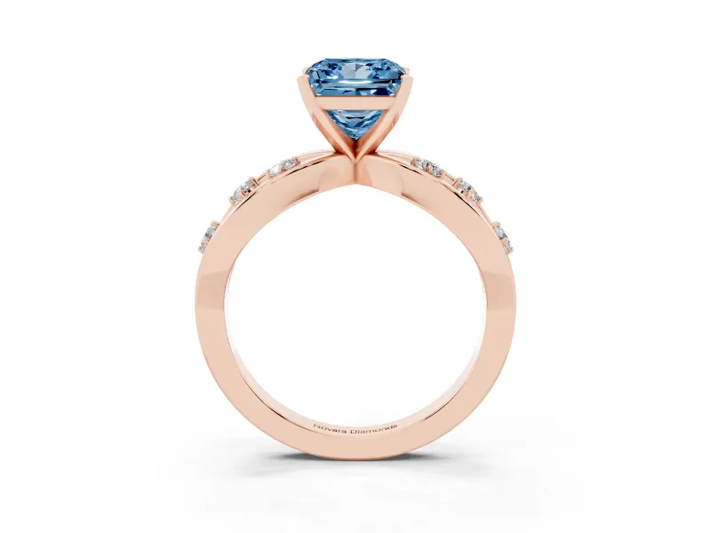 Fancy Blue Princess Cut Diamond Solitaire Ring Set in Rose gold with Side Stones on Criss-Cross Band and Prong Setting
