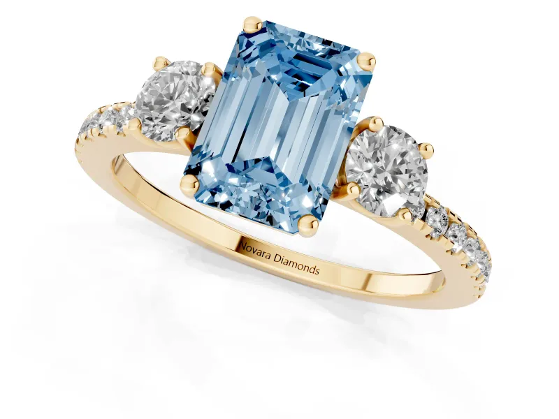 Emerald Cut Three Stone Engagement Ring Setting for a Fancy Blue Lab-Grown Diamond | Pave Shoulders | Yellow Gold