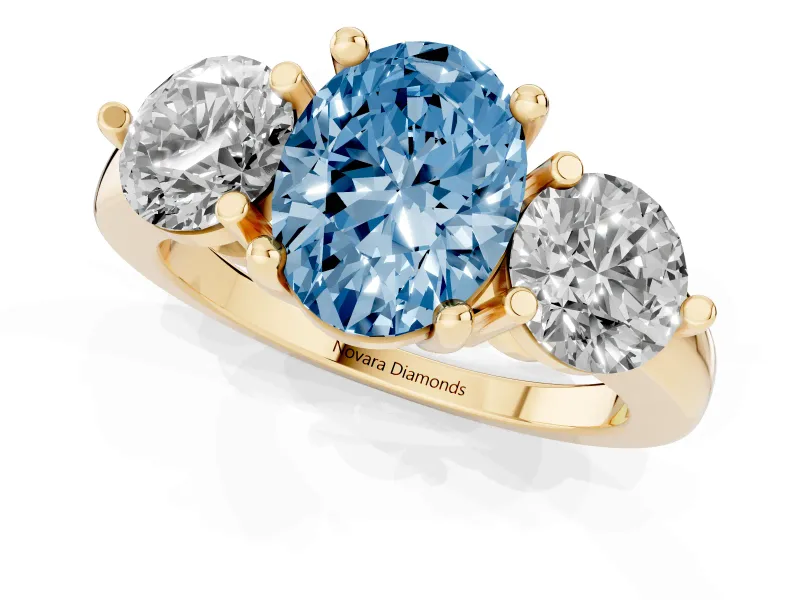 Fancy Blue Oval Cut Diamond Three-Stone Ring Set in Yellow gold with Prong Setting and Classic Band