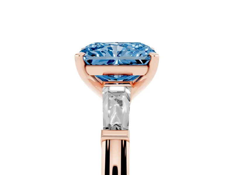 Fancy Blue Radiant Cut Diamond Solitaire Ring Set in Rose gold with Tapered Baguette Side Stones and Prong Setting