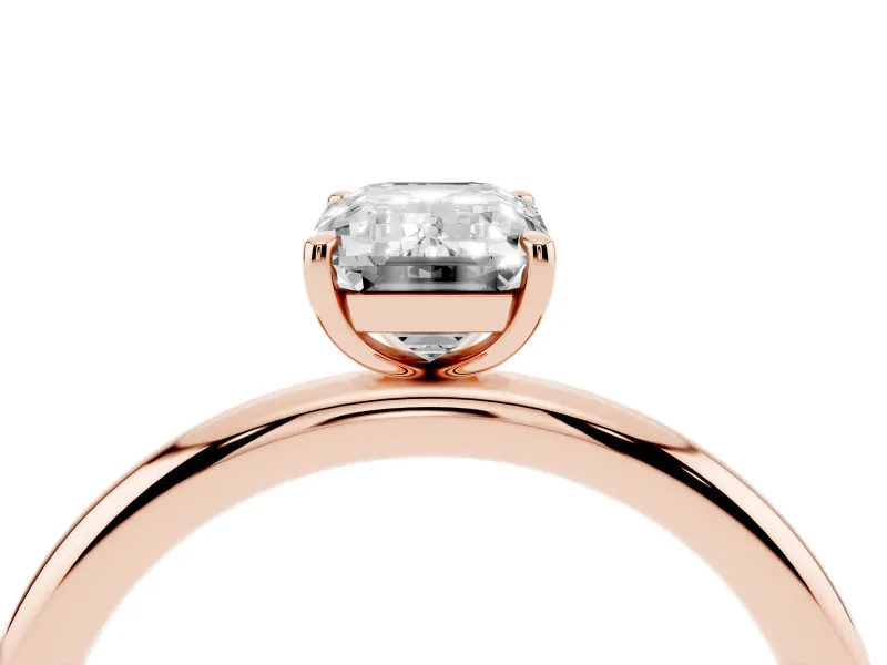 Emerald Cut Diamond Solitaire Ring Set in Rose gold with Prong Setting on a Polished Plain Band
