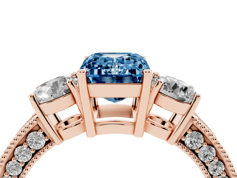 Fancy Blue Emerald Cut Diamond Three-Stone Ring Set in Rose gold with Round Side Stones and Pavé Band