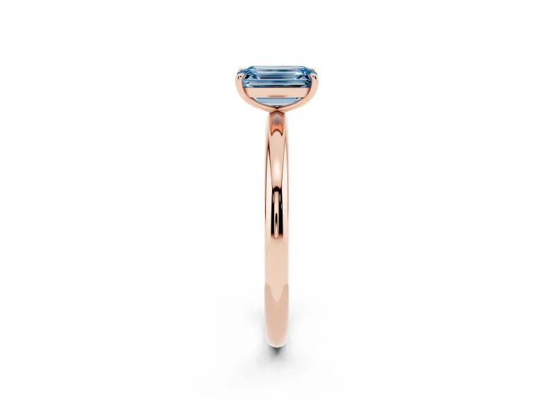 Fancy Blue Emerald Cut Diamond Solitaire Ring Set in Rose gold with Prong Setting on a Polished Plain Band