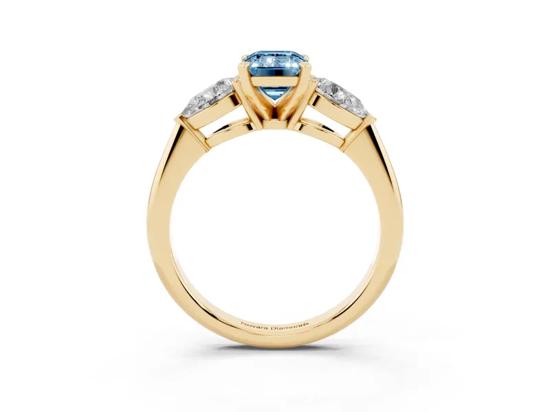 Fancy Blue Three-Stone Emerald Cut Diamond Ring Set in Yellow gold with Pear Side Stones and Prong Setting