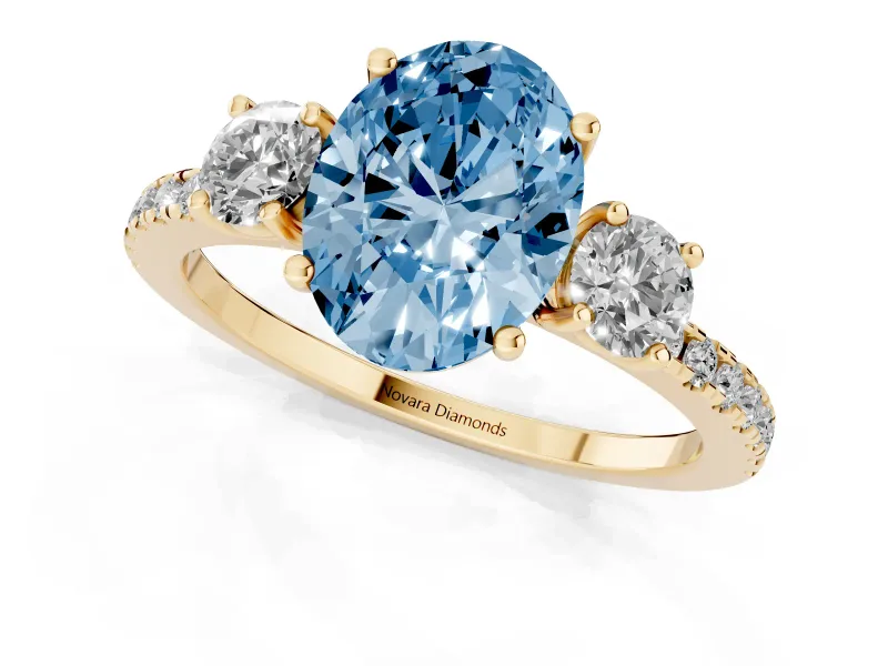 Fancy Blue Oval Cut Diamond Three-Stone Ring Set in Yellow gold with Pavé Band and Graduated Sides