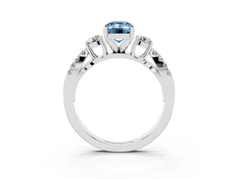 Fancy Blue Emerald Cut Diamond Three-Stone Ring Set in White gold with Pavé Split Shank and Prong Setting