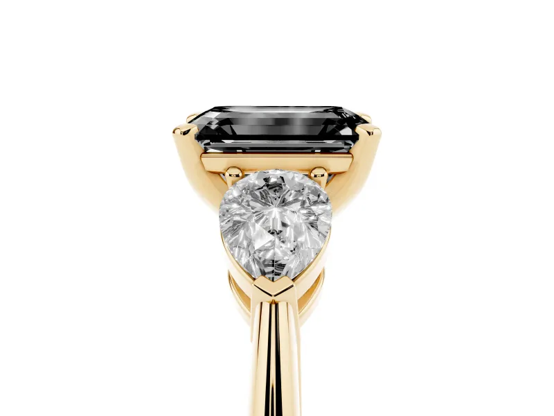 Fancy Black Three-Stone Emerald Cut Diamond Ring Set in Yellow gold with Pear Side Stones and Prong Setting