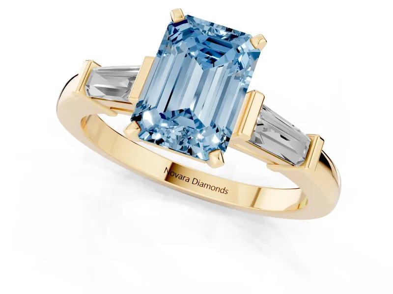 Fancy Blue Emerald Cut Diamond Solitaire Ring Set in Yellow gold with Tapered Baguette Accents and Prong Setting