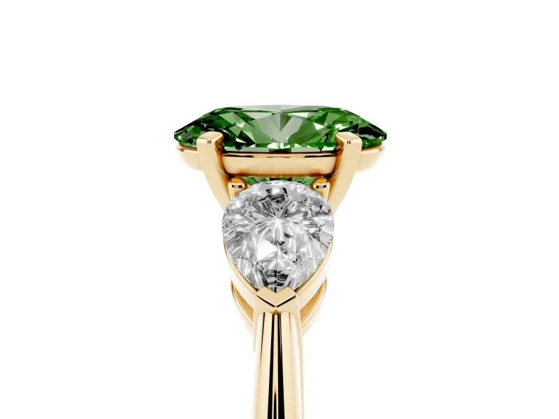 Fancy Green Three-Stone Oval Cut Diamond Ring Set in Yellow gold with Pear Side Stones and Prong Setting