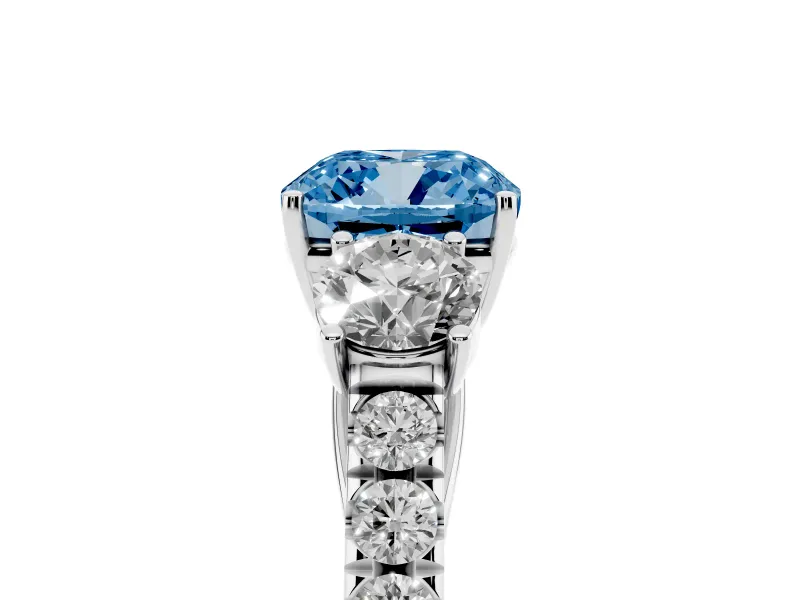 Fancy Blue Cushion Cut Diamond Three-Stone Ring Set in White gold with Round Side Stones and Delicate Pavé Band