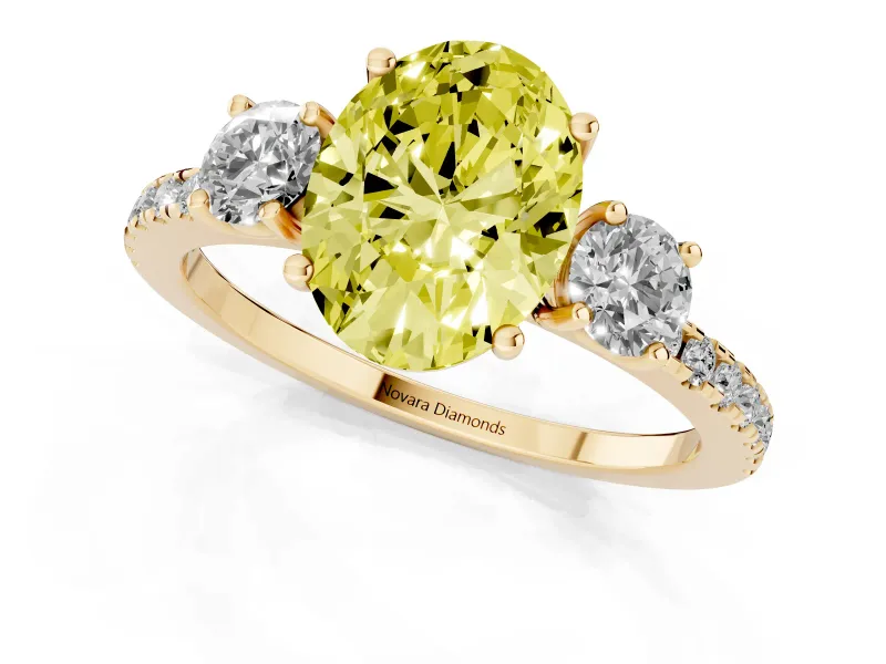 Fancy Yellow Oval Cut Diamond Three-Stone Ring Set in Yellow gold with Pavé Band and Graduated Sides