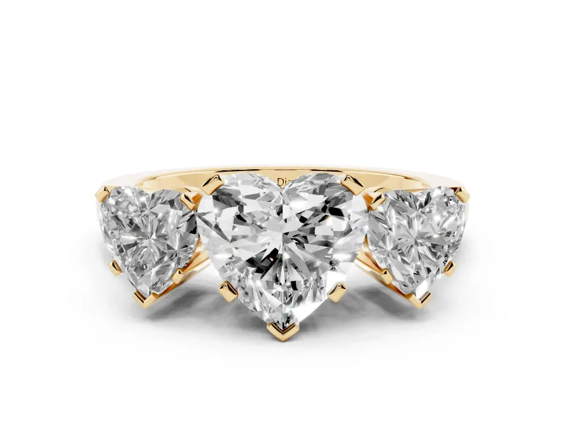 Heart Cut Diamond Three-Stone Ring Set in Yellow gold with Channel-Set Band and Prong Settings