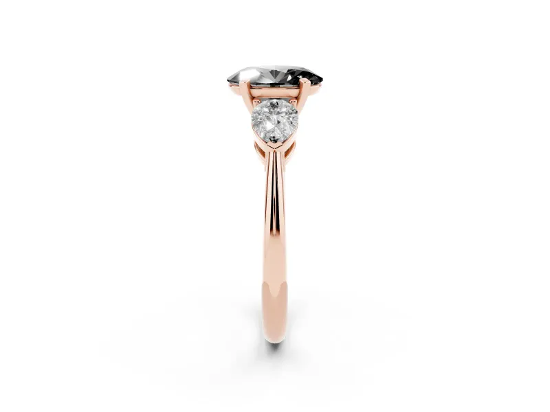 Fancy Black Three-Stone Oval Cut Diamond Ring Set in Rose gold with Pear Side Stones and Prong Setting