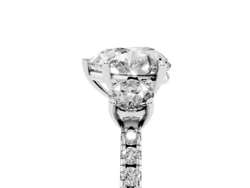 Heart Cut Diamond Three-Stone Ring Set in Platinum with Pavé Band and Graduated Sides